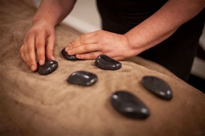What is the history behind hot stone massage?